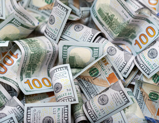 Hundred dollar rolled banknotes as background close-up.