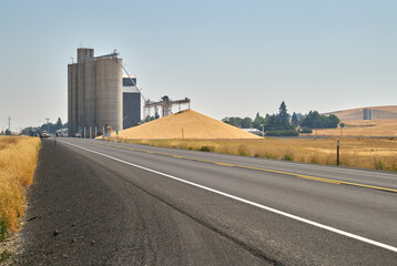 Grain Elevator and Wheat Pile. A stockpile of wheat at a grain elevator in Creston, Washington...