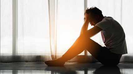 man sitting alone at home looking sorrow with desperate and depressed