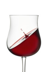 Red wine in wineglass isolated on white background. Drop falls into glass and creates splash and wave on surface of red wine