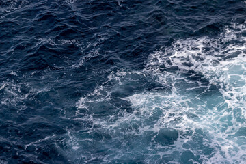 Fototapeta na wymiar Ocean seen from above, close, waves, pattern strong and powerful.