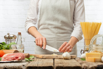 Chef cooking dishes with garlic, ingredients. Culinary and gastronomy