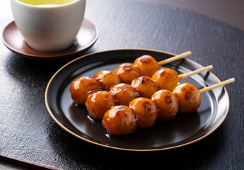 Mitarashi dango and green tea on a Japanese-style tray