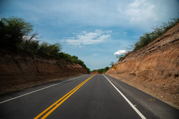 Vanishing point on the country road in a warm climate landscape. Colombia.