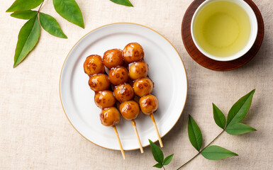 Mitarashi dango and green tea placed on a cloth