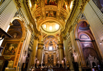 Fototapeta na wymiar The golden, ornately decorated interior napse, pews, dome and apse of the Basilica of Sant'Andrea della Valle in Rome, Italy.