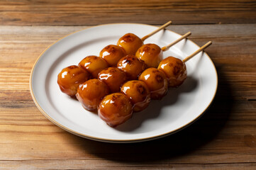 Mitarashi dango placed on a wooden background