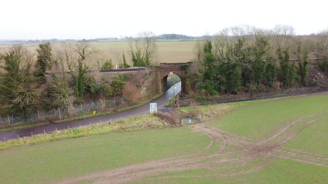 Drone footage flying away from railway bridge in the Kent countryside village.