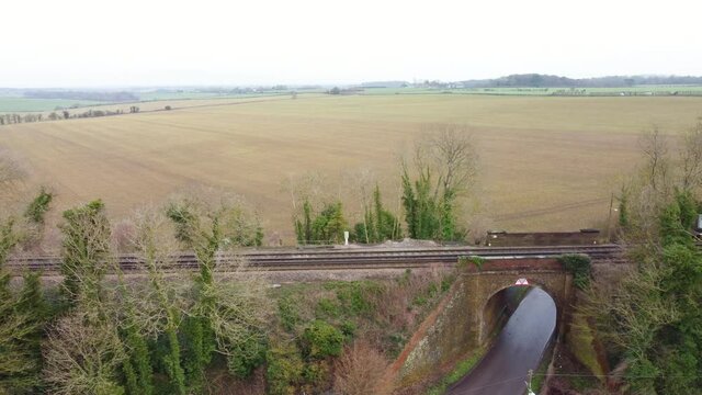 Drone footage flying alongside train tracks including a bridge in Kent. England