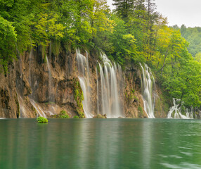 Fototapeta na wymiar long exposure shot of a waterfall and lake at plitvice lakes national park on a rainy spring day