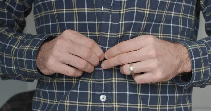 Buttoning up plaid shirt and unbuttoning plaid shirt