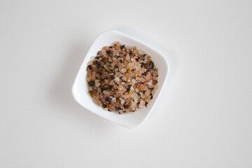 himalaya pink salt with red pepper on white plate.