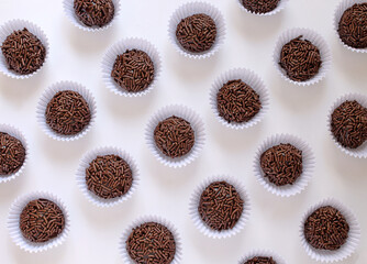 Sweet brigadeiro seen from above on white table.
