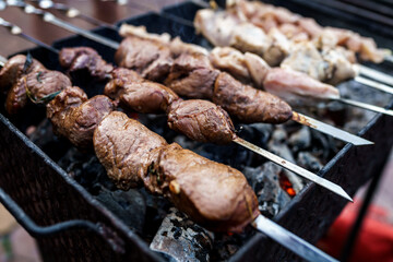 Shish kebab of elite veal skewered on a grill close-up outdoors