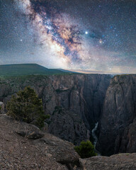 Fototapeta na wymiar Milky way over Black Canyon, Colorado. An awe night sky view with our galaxy above beautiful landscape wilderness. An idyllic and motivational scenery