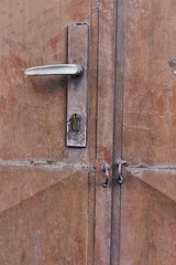Old grunge and dirty metal closeup of steel door with door handles and lock vintage retro style background and texture in Sofia, Bulgaria, Eastern Europe