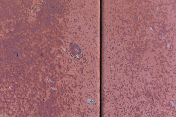 Plate of metal rusty texture with traces of red paint faint color corroded with age in Sofia, Bulgaria, Eastern Europe