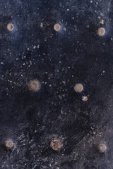 Aged dark leather texture top view of old couch chair surface detail black worn out with buttons Sofia, Bulgaria, Eastern Europe