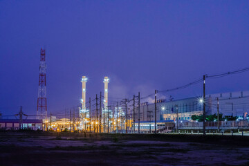 Fototapeta premium Night scene of oil refinery plant and storage factory, Industrial factory plant with beautiful light in dark night