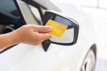 Closed up hand use credit card on car