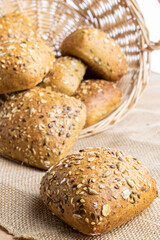 Loaf bread. Rye bakery with crusty loaves and crumbs. Fresh loaf of rustic traditional bread with wheat grain ear or spike plant on natural cotton background. Bio ingredients, very healthy seeds.