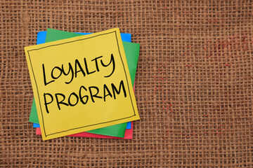Loyalty program, text words typography written on paper against wooden background, life and business motivational inspirational