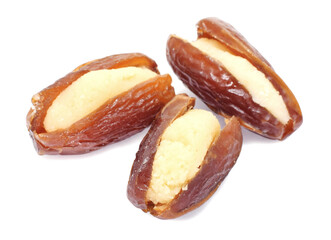 Dried dates fruits filled with marzipan paste closed up isolated on white