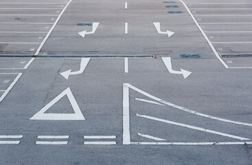 Car park with empty parking lot and arrow sign