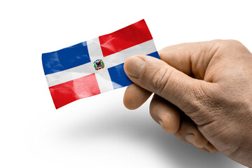 Hand holding a card with a national flag the Dominicana