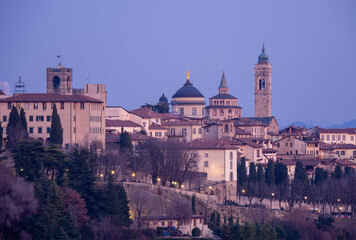 Fototapeta premium Bergamo. One of the beautiful city in Italy. Landscape at the old town from the hill during sunset. Amazing view of the towers, bell towers and main churches. Touristic destination. Best of Italy