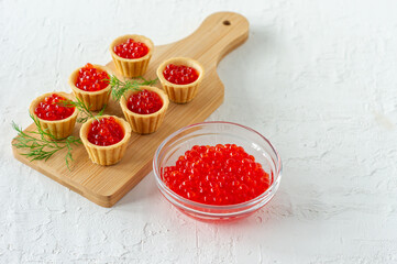 Tartlets with butter and red caviar. Gourmet food, appetizer. Delicatessen. Seafood.