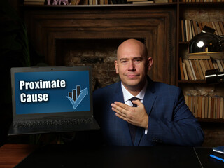 Man showing laptop with phrase Proximate Cause - closeup shot on grey background