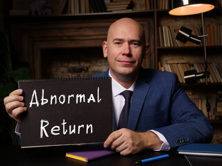  Abnormal Return phrase on black notepad.