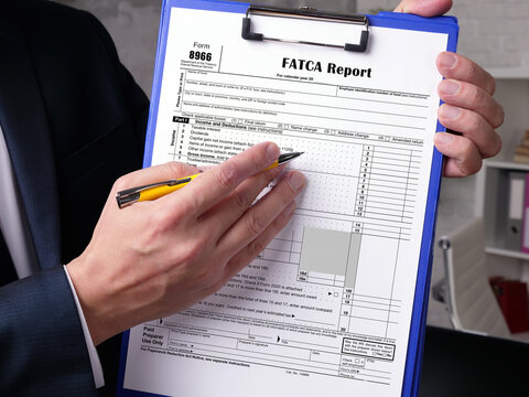 Business concept about Form 8966 FATCA Report with phrase on the piece of paper.