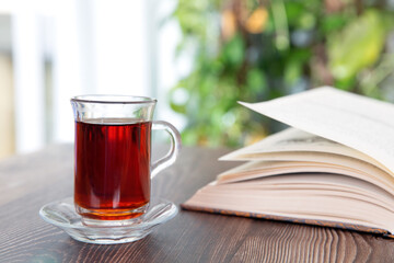 Open book and a cup of black tea