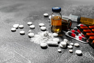 Ampoules and drugs on dark background