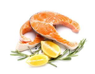 Raw salmon steaks and lemon on white background