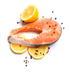 Raw salmon steak and lemon on white background