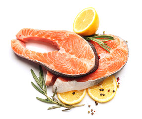 Raw salmon steaks and lemon on white background