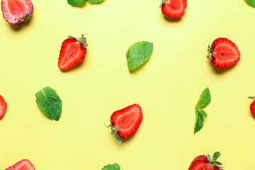 Cut strawberry and mint on color background