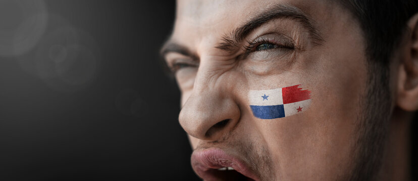 A screaming man with the image of the Panama national flag on his face - Powered by Adobe