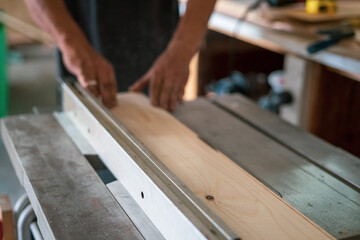 texture of color wood dust sparks over the table, view in the carpenter workshop.