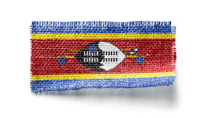 Swaziland flag on a piece of cloth on a white background