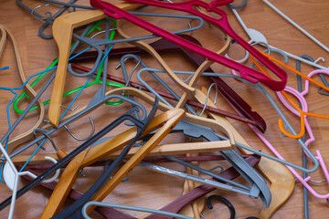 A lot of clothes hangers are on the floor. Preparation for cleaning the linen closet