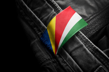 Tag on dark clothing in the form of the flag of the Seychelles