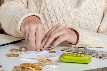 closeup businesswoman counting coins on the table
