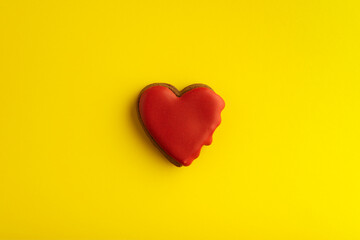 Homemade cookies shape of hearts with red sugar glaze. Valentines Day. Bright yellow background