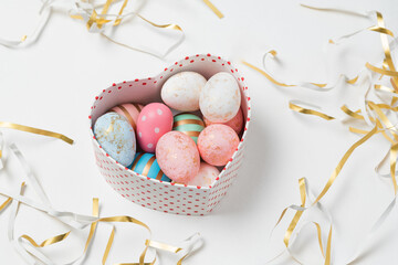 Fototapeta premium Easter eggs in pastel colors in heart shaped box. Happy Easter