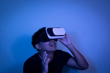 A man wearing virtual reality glasses touches video and new technology.