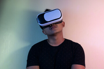 A man wearing virtual reality glasses touches video and new technology.